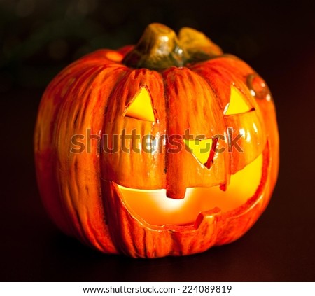 Halloween pumpkin head in dark, scary smile. Light inside.