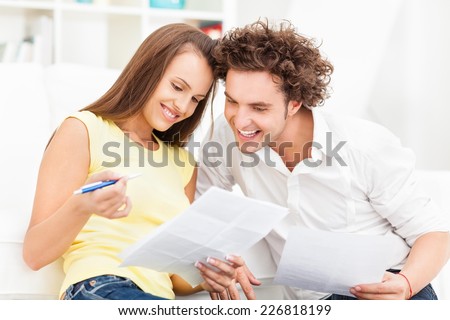 Young couple organizing their bills.