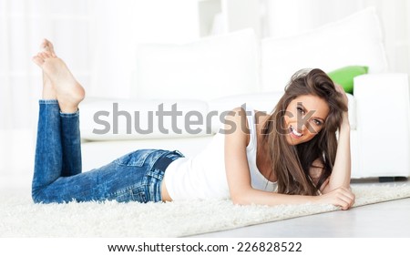 Beautiful girl lying on the floor at home.
