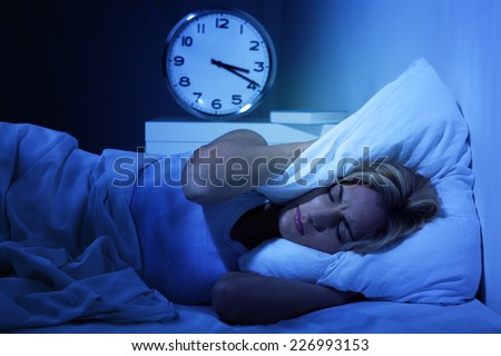 Woman awake early in the morning, having insomnia.