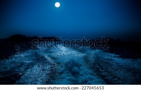 Full moon over sea surface.