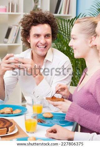 Three friends having breakfast at home.