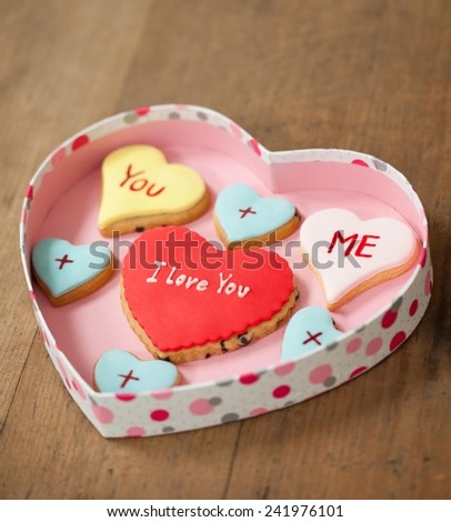 Cute heart shaped Valentine\'s cookies in a heart shaped box. I love you, you and me written on them.