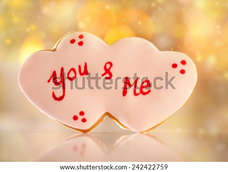 Cute heart shaped Valentine\'s cookie with You & Me written on it.