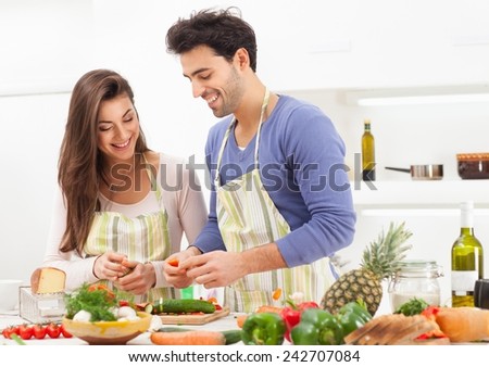 Romantic young couple preparing italian food at home.