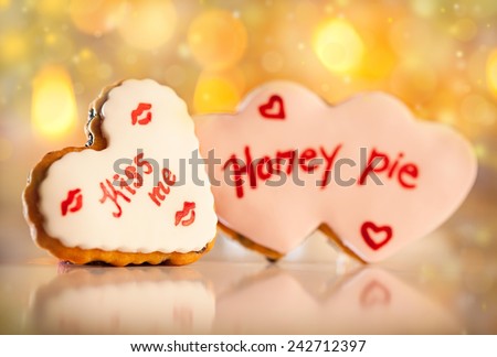 Cute heart shaped Valentine\'s cookies with Honey pie and kiss me written on it.
