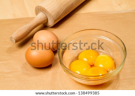 Selecting ingredients for cake, extracting egg whites and yolks