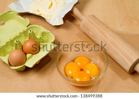 Selecting ingredients for cake, extracting egg whites and yolks, butter and eggs package