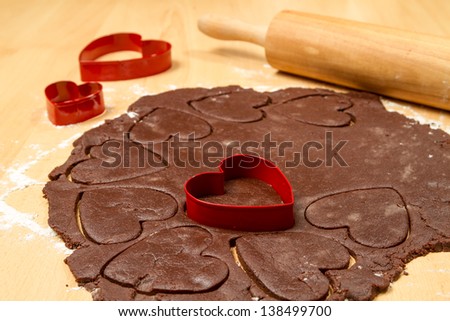 Rolling and cutting hearts of chocolate cake