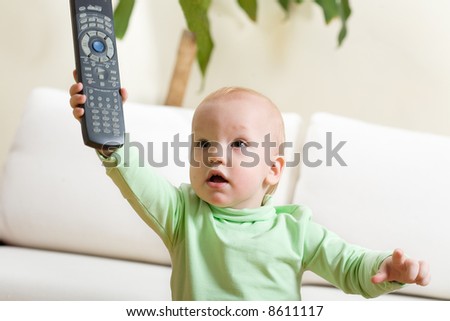 Father switch on a TV, please! Cute little boy at home reach remote control to parent and want to watch TV.