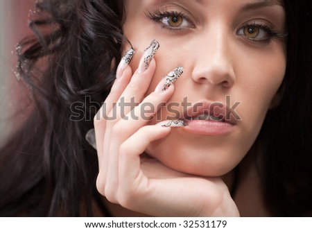 Portrait of attractive girl with beautiful hairstyle and long nails