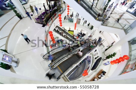 People make shopping in big modern mall. Crowd in motion blur