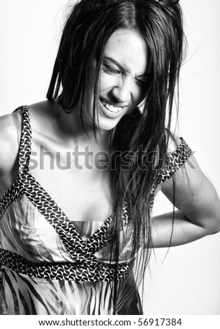 BW portrait of attractive emotional brunette girl with beautiful hairstyle in fashion sundress