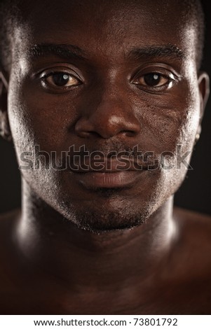 A young black man staring at you