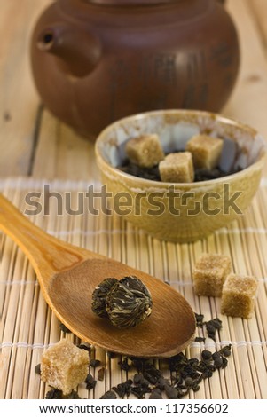 Asian tea, ceramic teapot on bamboo napkin