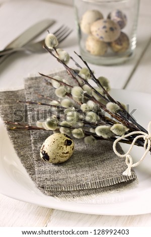 Easter table setting  with quail eggs, willow branches