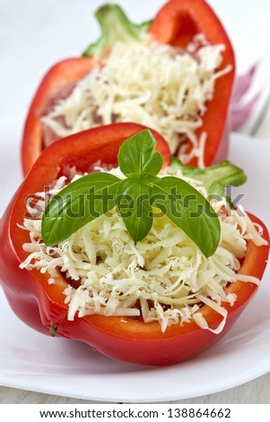 stuffed peppers dusted with cheese before baking