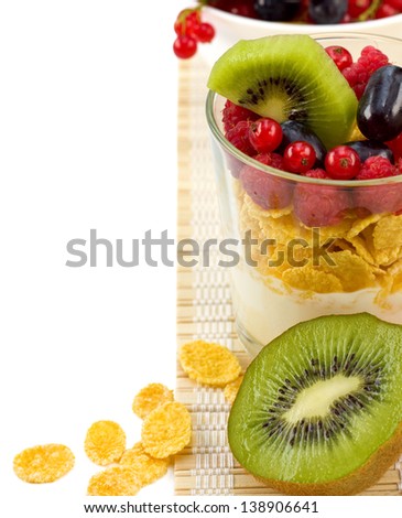 Breakfast cereal with berries, raspberries, red currants, kiwi and yogurt with a glass beaker