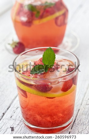 lemonade with strawberries on a wooden background