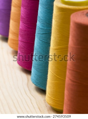 several of multi-colored spools of threads