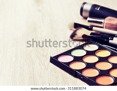 Professional makeup palette, makeup brushes, makeup products  with copyspace (Toning, instagram filter)