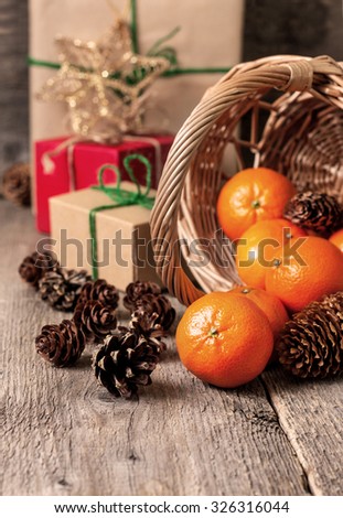 Christmas decorations with Christmas presents, tangerines and cones in a basket