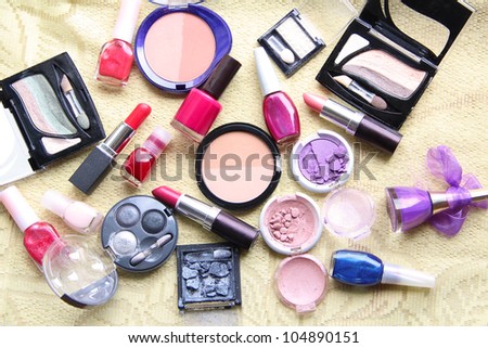 Make up assortment: lipsticks, nail polishes, blusher, eye shadows, foundation and powder of different colours