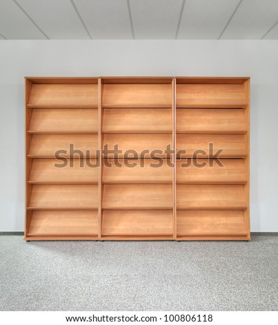 Empty Wooden Bookshelf on the Gray Wall