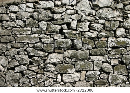 Rustic stone wall with strong gaps between stones