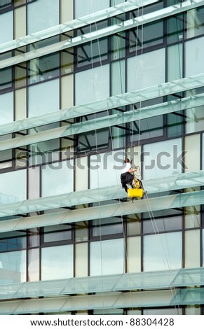 Window washer hanging outside facade