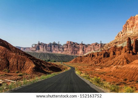 A road through Capitol Reef National Park / Capitol Reef Road / A road cuts through the mountains at Capitol Reef National Park, Utah.