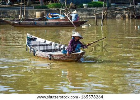 HOI AN, VIETNAM - NOVEMBER 11: A local Vietnamese fishermen crosses the river in a canoe in Hoi An, Vietnam on November 11 2013.