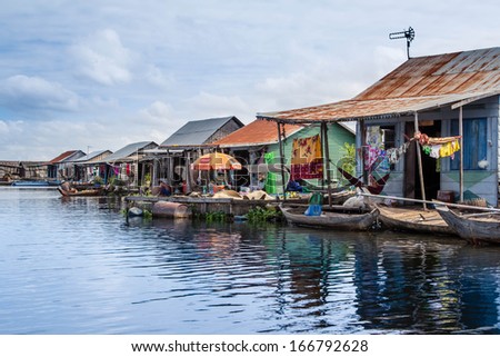 SIEM REAP, CAMBODIA - NOVEMBER 8, 2013; A floating village goes about it\'s day on the Tonie Sap or Great Lake, on November 8, 2013 in Cambodia