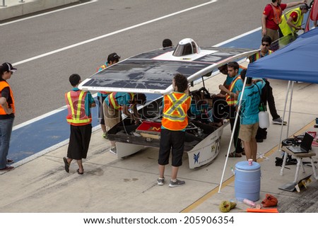 AUSTIN, TX -JULY 19: Students work on their solar car during the Formula Sun Grand Prix at the Circuit of The Americas in Austin, TX on July 19 2014.