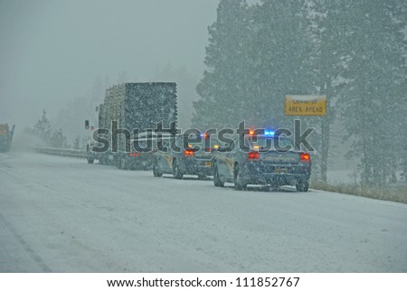 I-84, EASTERN OREGON - JAN 24 :Police cars stop to assist  a large truck during a winter storm  on Jan 24, 2012  in Eastern Oregon
