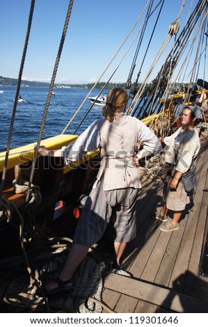 KIRKLAND, WASHINGTON - SEP 1:The crew sets the sails of the Lady Washington   during a mock sea battle as part of Labor Day festivities on Sep 1, 2012 near Kirkland , Washington.