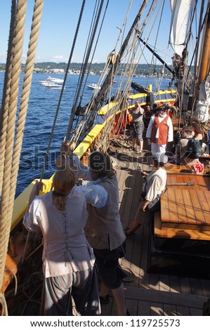 KIRKLAND, WASHINGTON - SEP 1 :The crew sets the sails of the Lady Washington    during a mock sea battle as part of Labor Day festivities on Sep 1, 2012 near Kirkland , Washington.