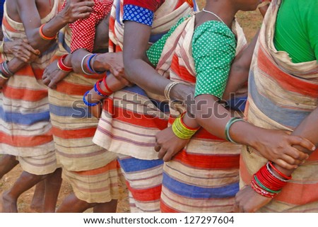 Tribal women link arms for 	Gdaba harvest dance  in Lamptaput, Orissa, India
