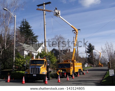 SEATTLE - FEB 7 - Seattle City Light workmen replace an aging utility pole as part of a city wide project to improve electrical reliability,  on Feb 7, 2013 in Seattle.