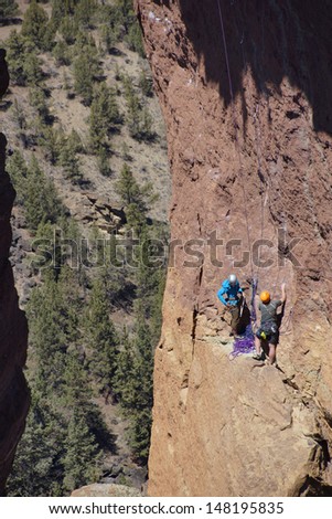 Climbers on  the overhanging cliff of Monkey Face, one iof the premier climbs in the Smith Rock area, Central Oregon