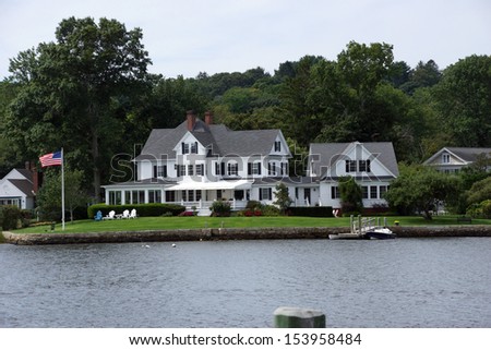 Historic New Enlgand mansions across the Thames river from wooden piers and wharfs, Old Mystic Seaport, Connecticut