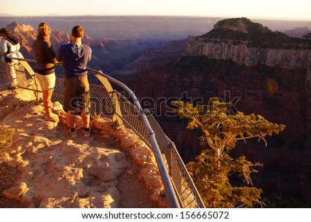 Tourists enjoy the sunset from Imperial Point on the North Rim of the Grand Canyon National Park, Arizona