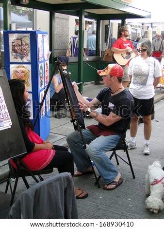 SEATTLE - MAY 15 -  An artist does portraits  at the U District Street Fair on May 15, 2010, in Seattle