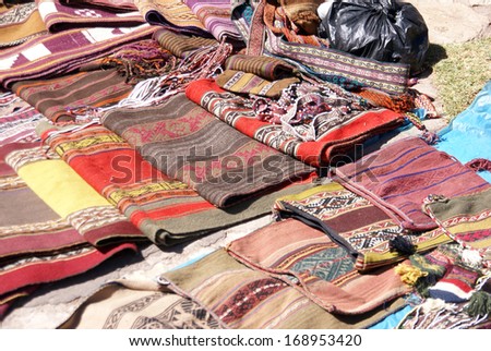 Colorful handmade blankets & tablecloths,	Pisac market, 	Cusco,	Peru, South America
