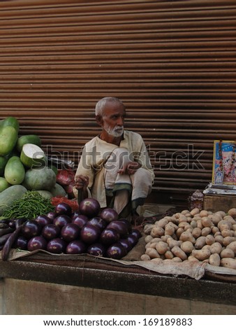 VARANASI, INDIA - NOV 7, 2009 - Unidentified Hindu man sells vegetables on the street on Nov 7, 2009, in Varanasi, India.