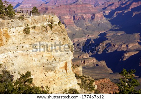 Tourists looking over the canyon  in early morning near the South Rim, at the Grand Canyon National Park, Arizona