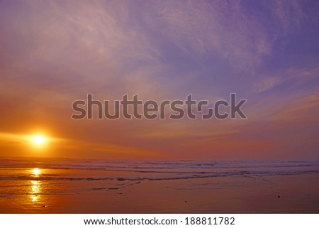 Dramatic ocean sunset with clouds and blue sky  near Yaquina Head, Newport, Oregon coast