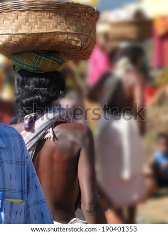 Woman carrying basket on her head weekly market  in Orissa,  in Chatikona market, Orissa, India