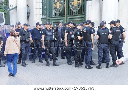 ISTANBUL - MAY 18, 2014 - Police in riot gear await orders during a protest demonstration near Taksim Square  in Istanbul, Turkey
