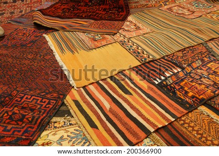 Overlapping carpets with intricate Kurdish  patterns in rug store  in Istanbul, Turkey